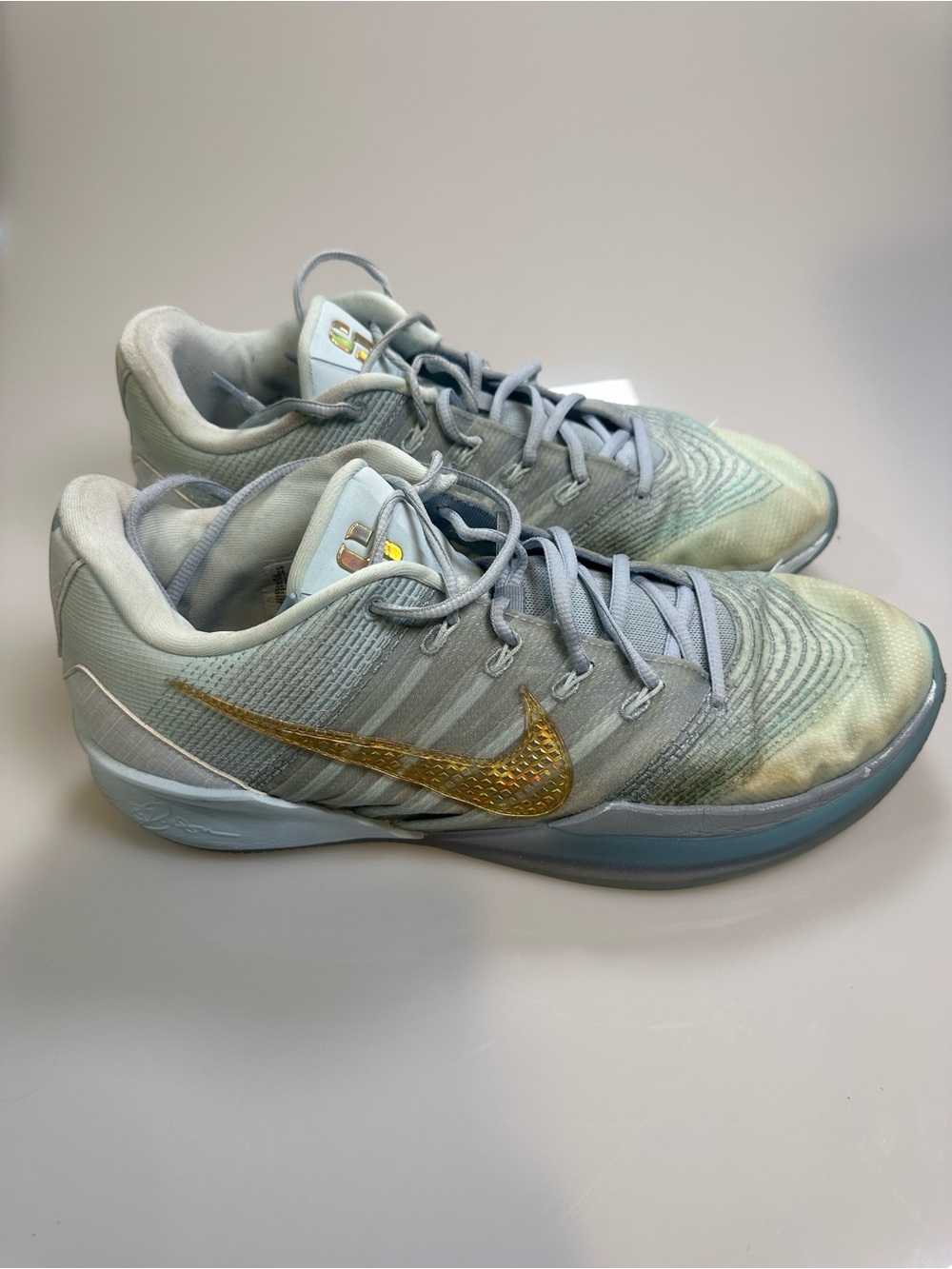 Nike Women’s Light Blue Sneakers with Gold Swoosh